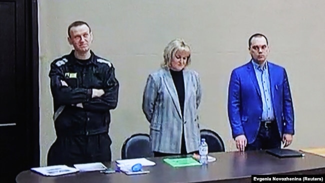 Aleksei Navalny (left) appears with his lawyers Olga Mikhailova (center) and Vadim Kobzev appear via a video link during a court hearing in March 2022.